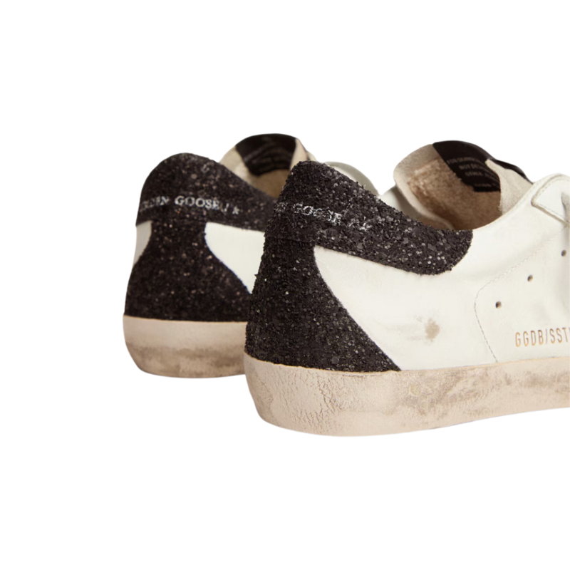 Golden Goose Women’s Super-Star in nappa leather with gold glitter star and black glitter heel tab.